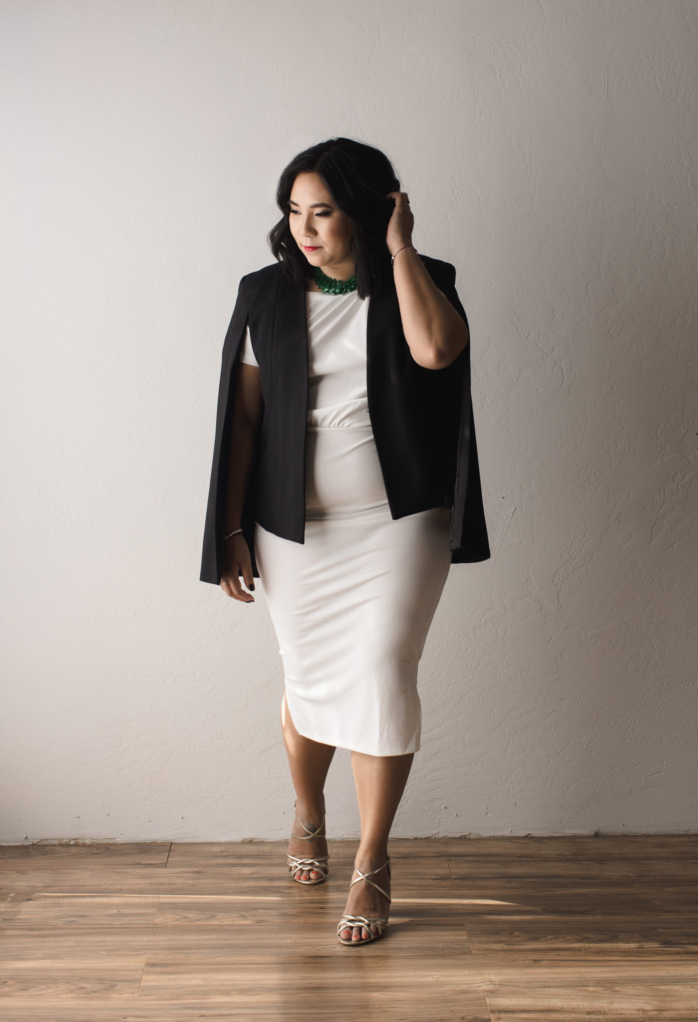 Photo of Kim in a white dress with a black blazer